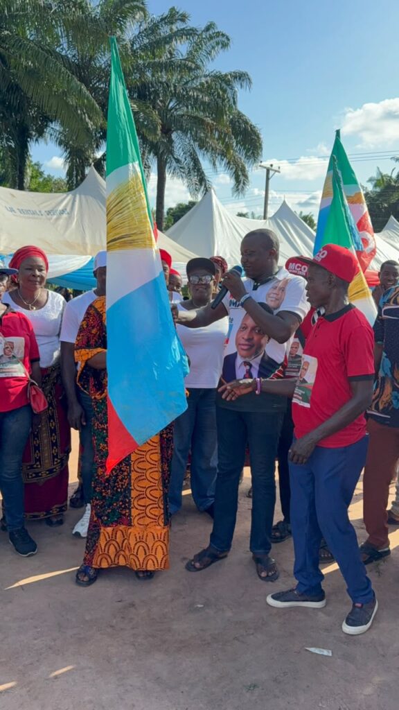 Nkanu East APC Chairman, Hon. Abel Nwigwe, handing over the party flag to the councillorship candidates