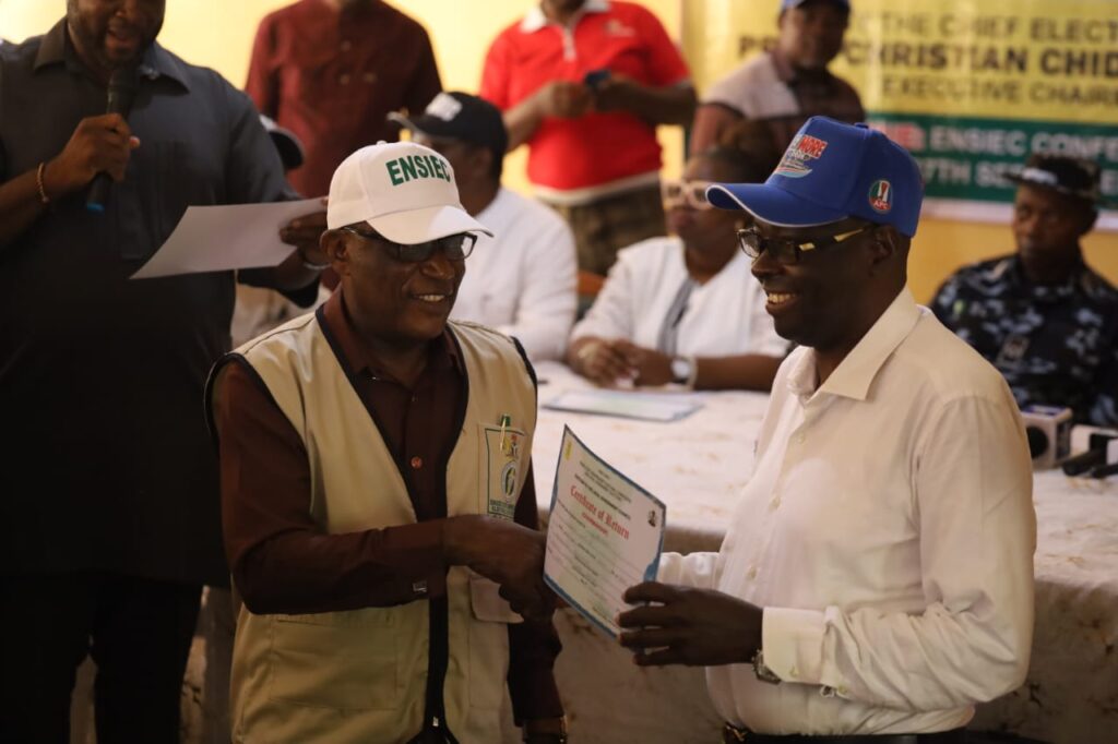 Udenu LGA Chairman Elect, Dr. Innocent Ezeoha, receiving his certificate of return