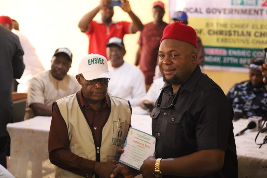 Uzo-uwani LGA Chairman, Hon. Chijioke Ezugwu, receiving his certificate of return
